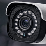 Close-up of a 1080P outdoor CCTV security camera lens with rain droplets, showcasing its clarity and night vision capabilities.